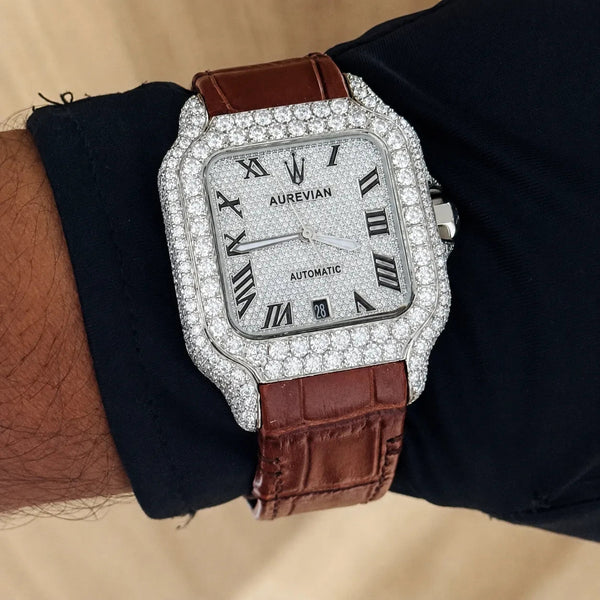 Platonic Aurevian automatic watch with a stone-encrusted square case, silver dial, and brown alligator leather strap.